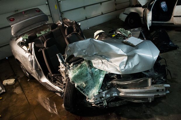 Severely damaged car in a garage.