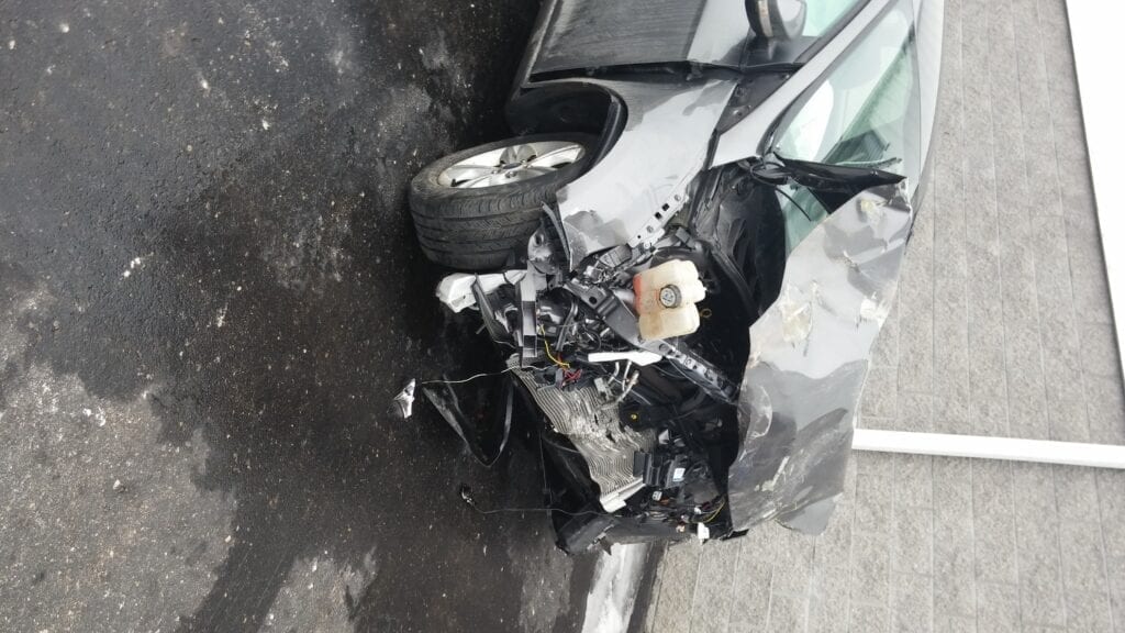 Car with severe front-end collision damage.
