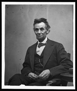 Man sitting in a suit, historical portrait.